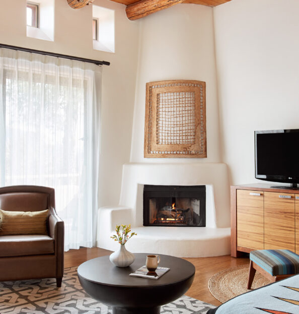 Living area with couch, tv, fireplace and chairs