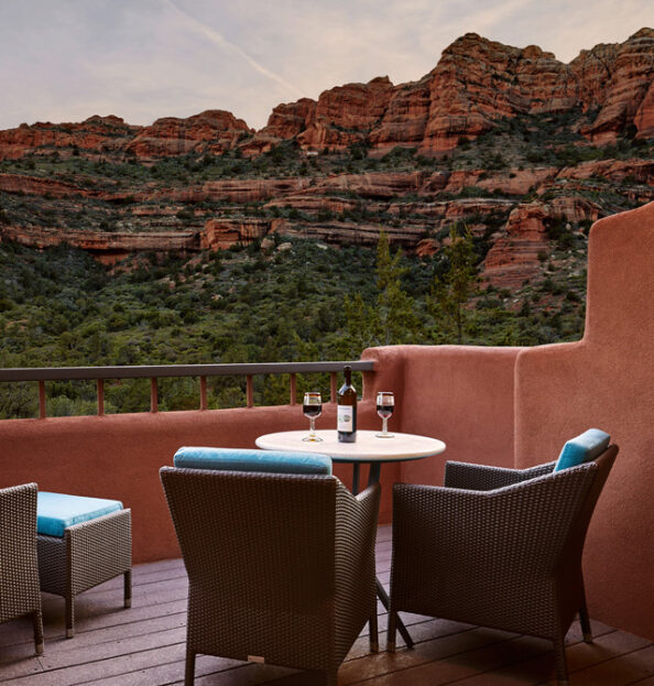 wine bottle with two glasses on balcony